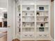A built-in bookshelf stands in front of a glimpse of the living room with fireplace at 1319 Glen Cedars Dr, Smyrna, GA 30126
