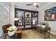 Cozy home office with built-in bookshelves, comfortable seating, and a well-lit desk area at 1319 Glen Cedars Dr, Smyrna, GA 30126
