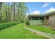 Beautiful backyard featuring a charming screened-in porch and stone walkway with lush greenery at 1478 Biltmore Ne Dr, Atlanta, GA 30329