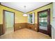Dining area with yellow patterned wallpaper, classic lighting, and a door leading to the outside at 1478 Biltmore Ne Dr, Atlanta, GA 30329
