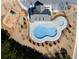 Overhead shot showcases a community pool, playground, and picnic pavilion, highlighting recreational amenities at 8192 Bluewater Dr, Fairburn, GA 30213