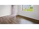 Bright living room with hardwood floors, a large window, and fresh, neutral paint throughout at 8192 Bluewater Dr, Fairburn, GA 30213