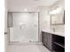 Modern bathroom with glass shower, gray cabinets, and herringbone-patterned floors at 870 Gaston Sw St, Atlanta, GA 30310