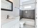 Modern bathroom with white vanity, a framed mirror, tiled shower with tub, and hexagon tile floor at 870 Gaston Sw St, Atlanta, GA 30310