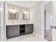 Well-lit bathroom featuring double vanity, gray cabinets, and herringbone-patterned floors at 870 Gaston Sw St, Atlanta, GA 30310