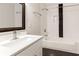 Modern bathroom featuring subway tile walls, black accent stripe, and a large framed mirror at 870 Gaston Sw St, Atlanta, GA 30310