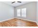 Cozy bedroom with hardwood floors, a ceiling fan, and two windows providing natural light at 870 Gaston Sw St, Atlanta, GA 30310