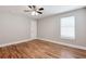 A bright, empty bedroom with hardwood floors and a ceiling fan at 870 Gaston Sw St, Atlanta, GA 30310