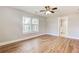 Spacious bedroom with hardwood floors, a ceiling fan, and light-filled windows at 870 Gaston Sw St, Atlanta, GA 30310
