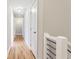 Hallway with hardwood floors, neutral walls, white trim, and overhead lighting at 870 Gaston Sw St, Atlanta, GA 30310