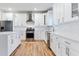 Elegant kitchen features white cabinetry, stainless steel appliances, and quartz countertops at 870 Gaston Sw St, Atlanta, GA 30310