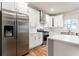 Bright, modern kitchen with stainless steel appliances, white cabinets, and a center island at 870 Gaston Sw St, Atlanta, GA 30310