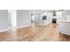 Open-concept living room with hardwood floors connecting to a kitchen with an island and stainless appliances at 870 Gaston Sw St, Atlanta, GA 30310