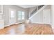 Bright living room features hardwood floors, large windows, and a staircase with modern railings at 870 Gaston Sw St, Atlanta, GA 30310