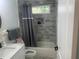 Bright bathroom with a shower-tub combination and gray tile surround at 1841 Bayberry Sw Dr, Atlanta, GA 30311