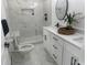 Modern bathroom features sleek white marble tile, a spacious walk-in shower, and elegant black fixtures at 1841 Bayberry Sw Dr, Atlanta, GA 30311