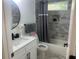 Bathroom featuring a shower-tub combination and gray tile surround, vanity and sink at 1841 Bayberry Sw Dr, Atlanta, GA 30311