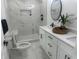 A modern bathroom with a glass enclosed shower, double vanity, and tiled flooring at 1841 Bayberry Sw Dr, Atlanta, GA 30311