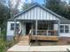 Charming craftsman home features a covered porch with a ceiling fan and a manicured lawn at 1841 Bayberry Sw Dr, Atlanta, GA 30311