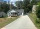 Charming cottage-style home features a covered porch and a long driveway at 1841 Bayberry Sw Dr, Atlanta, GA 30311