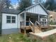 Inviting home with a charming front porch, gray siding, and new wood railings at 1841 Bayberry Sw Dr, Atlanta, GA 30311