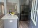 Modern gray kitchen with stainless steel refrigerator and island with white countertop at 1841 Bayberry Sw Dr, Atlanta, GA 30311
