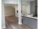 An open-concept kitchen area with light grey cabinets, quartz countertops, and wood flooring at 1841 Bayberry Sw Dr, Atlanta, GA 30311