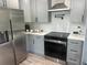 Modern kitchen features stainless steel appliances, quartz countertops, and a subway tile backsplash at 1841 Bayberry Sw Dr, Atlanta, GA 30311