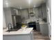 A modern kitchen with grey cabinets, quartz countertops, stainless steel appliances, and wood flooring at 1841 Bayberry Sw Dr, Atlanta, GA 30311