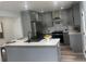 A modern kitchen with grey cabinets, quartz countertops, stainless steel appliances, and wood flooring at 1841 Bayberry Sw Dr, Atlanta, GA 30311