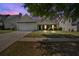 Inviting single-story home with an attached two-car garage, landscaped yard, and a tree-lined street at 2793 Saddle Horn, Snellville, GA 30039