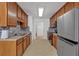 Well-equipped galley kitchen with wood cabinets, stainless steel appliances, and efficient workspace layout at 2793 Saddle Horn, Snellville, GA 30039