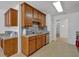 Efficient galley kitchen featuring wood cabinetry, stainless appliances, and a convenient layout with access to the dining area at 2793 Saddle Horn, Snellville, GA 30039