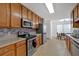 Galley kitchen boasts ample storage, stainless steel appliances, and a cozy dining area with natural light at 2793 Saddle Horn, Snellville, GA 30039