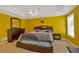 Cozy main bedroom featuring a queen bed, dresser and bright yellow accent walls at 2793 Saddle Horn, Snellville, GA 30039