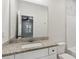Bathroom featuring granite countertops, a modern sink, and a large mirror reflecting the bedroom at 3143 Lee Cir, Buford, GA 30518