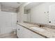 Well lit bathroom featuring a granite countertop, sleek single sink, modern lighting and updated shower/tub at 3143 Lee Cir, Buford, GA 30518
