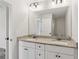 A luxurious bathroom featuring a double vanity with granite countertops, a large mirror, and a neutral color palette at 3143 Lee Cir, Buford, GA 30518