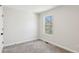 A bright, carpeted bedroom with a window provides a serene and peaceful atmosphere for relaxation and rest at 3143 Lee Cir, Buford, GA 30518