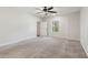Spacious bedroom featuring plush carpeting, a ceiling fan, and a bright window at 3143 Lee Cir, Buford, GA 30518