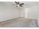 Large carpeted bedroom features a ceiling fan, a window for natural light, and a door to an adjacent bathroom at 3143 Lee Cir, Buford, GA 30518