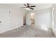 An open bedroom with carpet, two doors, and a window provides access to the bathroom, enhancing convenience at 3143 Lee Cir, Buford, GA 30518
