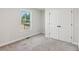 A spacious bedroom showcasing natural light from the window and a sizable closet, offering ample storage at 3143 Lee Cir, Buford, GA 30518