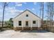 Charming single-story home featuring a gabled roof, white siding, and inviting brick-base front porch at 3143 Lee Cir, Buford, GA 30518