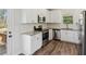 Modern kitchen featuring white cabinets, stainless steel appliances, and granite countertops, offering style and functionality at 3143 Lee Cir, Buford, GA 30518