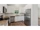 Modern kitchen featuring stainless steel appliances, granite countertops, and white cabinetry at 3143 Lee Cir, Buford, GA 30518