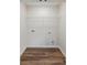 Laundry room featuring dark wood vinyl floors and a storage rack at 3143 Lee Cir, Buford, GA 30518