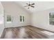 Bright living room with hardwood floors, high ceilings, and a door leading to a covered patio at 3143 Lee Cir, Buford, GA 30518