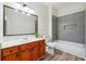 Modern bathroom with gray tile, tub, and oak vanity, providing a refreshing aesthetic at 4419 Bellwood Cir, Atlanta, GA 30349