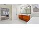 Bright bathroom with marble floors, double vanity, and bathtub visible from doorway at 4419 Bellwood Cir, Atlanta, GA 30349
